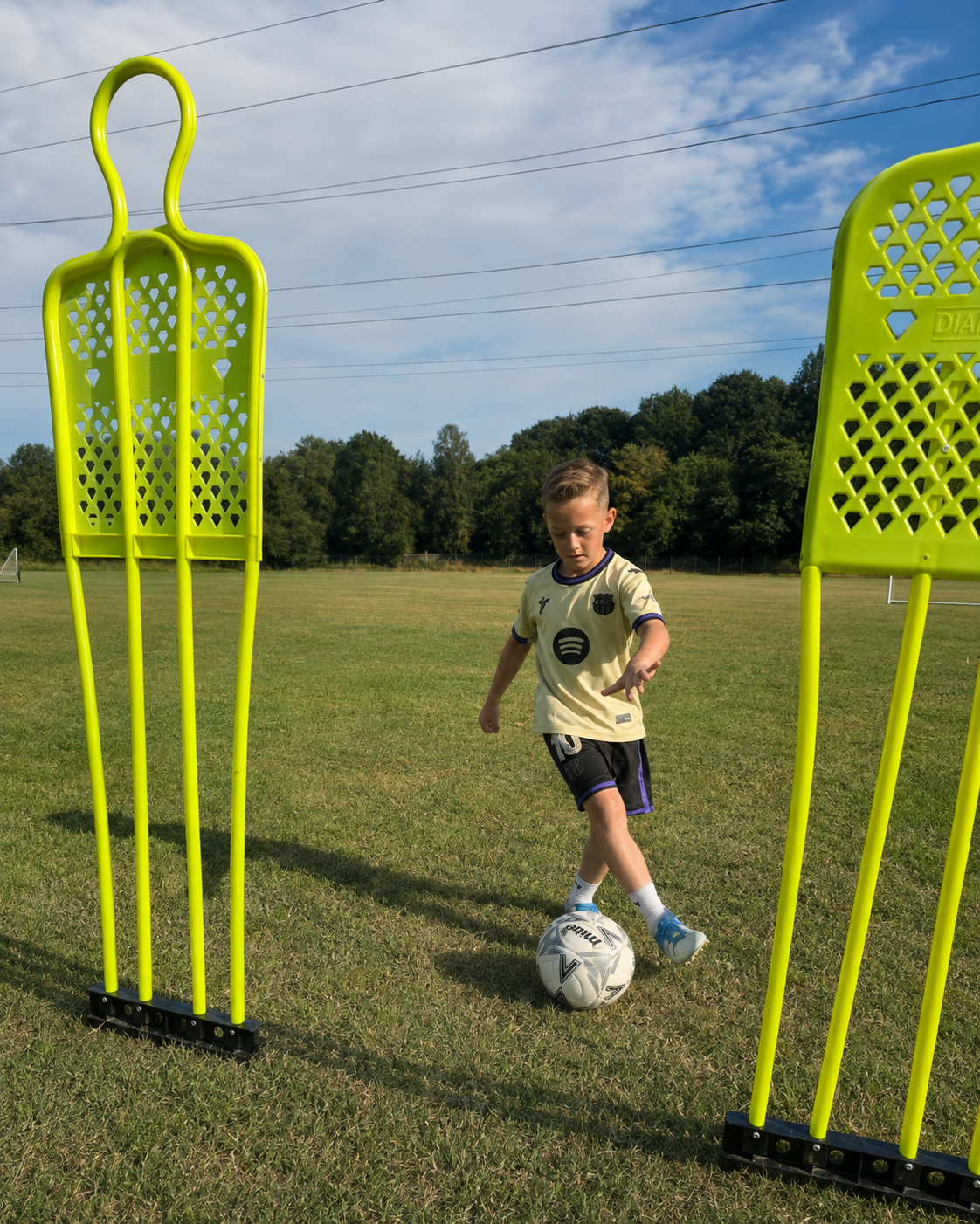 Young player dribbling through a mannequin gate
